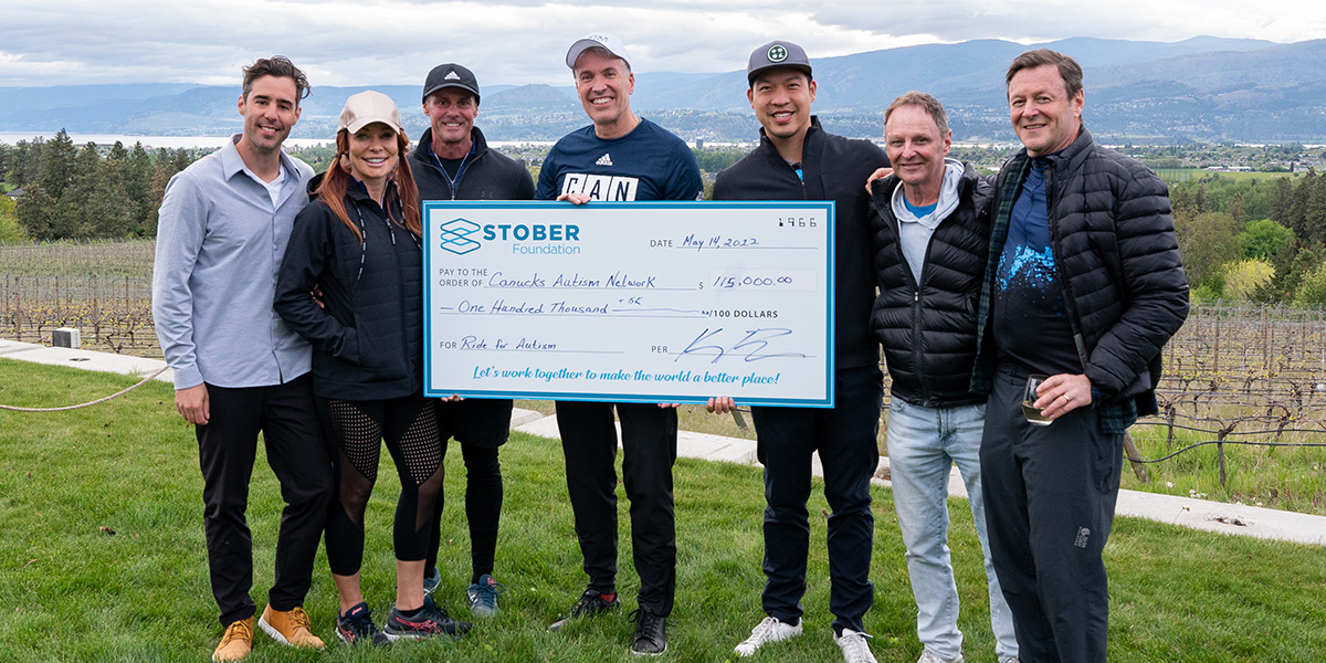 Stober Foundation presents a cheque for $115,000 to Canucks Autism Network at the 2022 ride